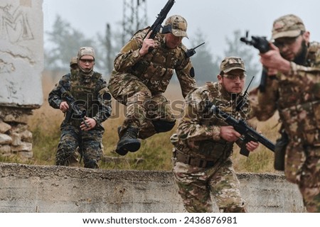 A highly trained elite military unit, clad in camouflage, skillfully navigates through perilous forest terrain, overcoming obstacles and executing a precise and covert mission Royalty-Free Stock Photo #2436876981