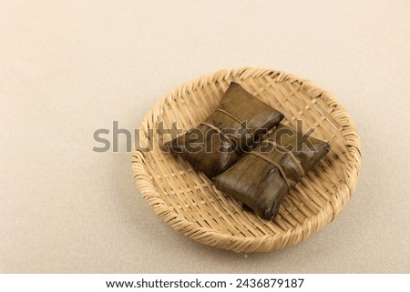 Buras or Burasa, Indonesian Style Rice Dumpling with Banana Leaf Wrapping. Royalty-Free Stock Photo #2436879187