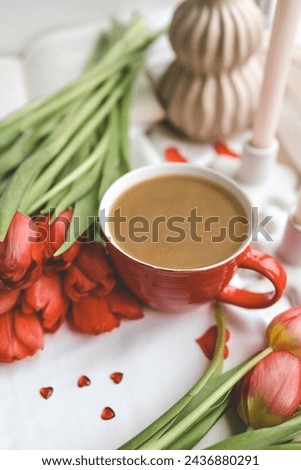 Cup of coffee, tulips and candles, spring atmosphere.