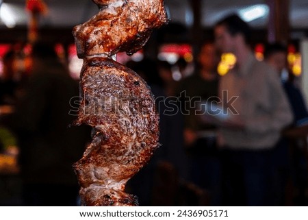 Brazilian style beef ribs Barbecue grill on skewers  at a churrascaria steakhouse in Brazil. Royalty-Free Stock Photo #2436905171