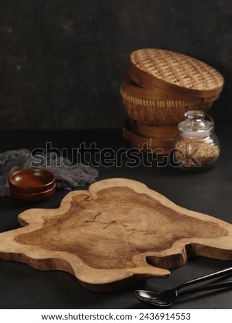 food photography composition for commercial traditional photography, with dark background, served on wooden cutting board, small wooden bowl 

