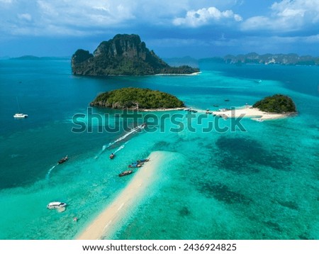 Chicken Island and Tub Island in Thailand. Top aerial drone view of a paradise beach, ocean, white sand, mountains, cliffs, and boats