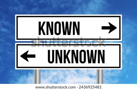 Known or unknown road sign on cloudy sky background Royalty-Free Stock Photo #2436925481