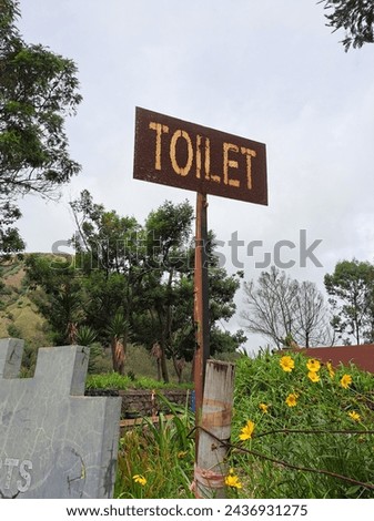 old rustic toilet sign in the garden at bromo volcano 