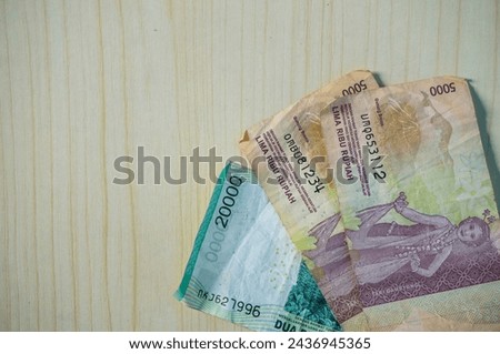 Rupiah banknote on wood background. Money photo concept.