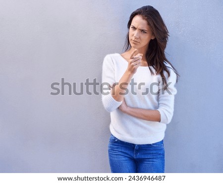 Studio, portrait and woman with doubt, point and feeling suspicious with rumor of news and opinion. Gesture, female person and girl with finger to show warning of guilty with serious decision Royalty-Free Stock Photo #2436946487