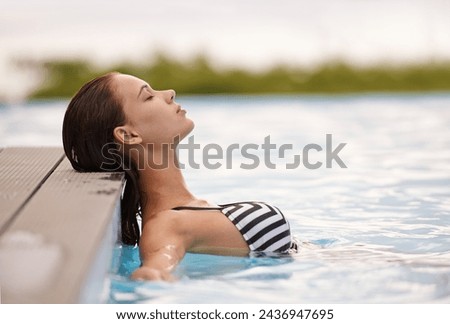 Summer, peace and woman relax in swimming pool on luxury holiday or vacation at hotel or villa in Cancun. Person, outdoor or enjoy calm water at resort in Mexico or girl in bikini or swimsuit fashion