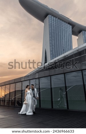 Bride and groom against the backdrop of the city of Singapore. Sunrise wedding photoshoot. 
