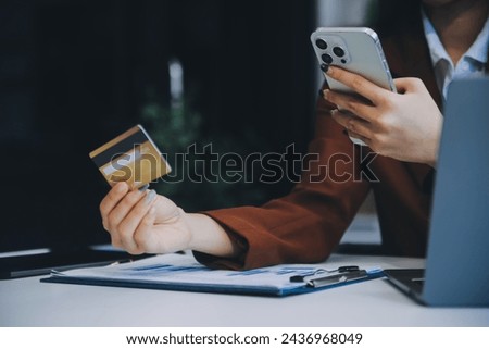 Hands holding plastic credit card and using laptop. Online shopping concept. Toned picture