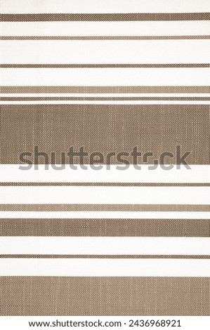 Classic Stripe Pattern on a Textured Fabric Background. The Elegant Simplicity of a Brown and White Textile Design Royalty-Free Stock Photo #2436968921