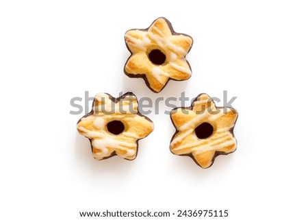 Three star-shaped cookies on a white background. Sweet shortbread cookies with frosting. With a shadow.