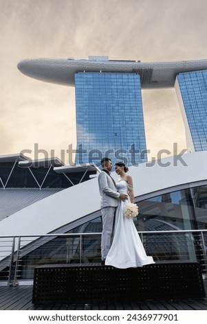 Bride and groom against the backdrop of the city of Singapore. Sunrise wedding photoshoot. 
