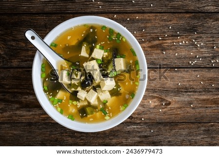 Miso soup - traditional Japanese soup with tofu on wooden table