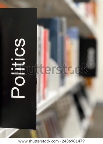 Politics sign on a political books shelf in a local public library.