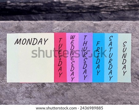 Days of the week with multicolor paper background. Stock photo.