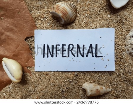 Infernal writting on beach sand background.
