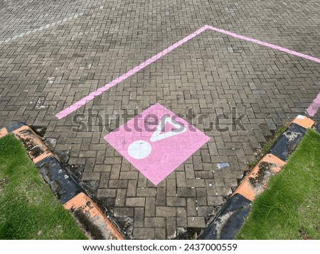 Paving block parking with unique pink parking lines and symbol in rest areas