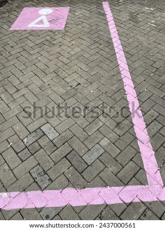 Paving block parking with unique pink parking lines and symbol in rest areas