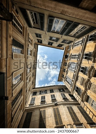 Street view from a courtyard looking up towards the sky Royalty-Free Stock Photo #2437000667