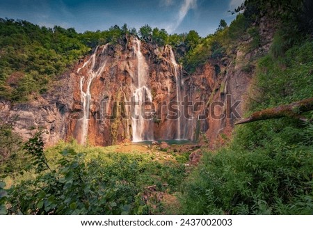 Majestic summer view of green forest with pure water waterfall. Picturesque morning scene of Plitvice National Park, Croatia, Europe. Beauty of nature concept background. Travel the world.

