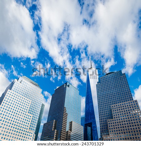 Skyscrapers rising up to blue sky with white clouds