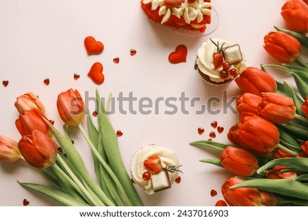 Beautiful festive background with place for text, tulips and sweets.