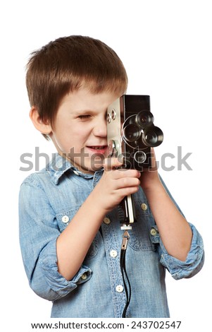 Little boy cameraman filming with retro camera isolated