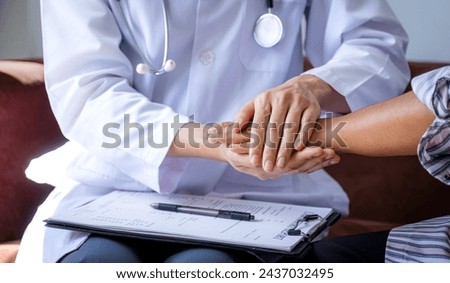 The doctor hands holding patient hand to encouragement and explained the health examination results, medical checkup concept.