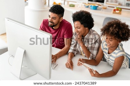 Obsessed to tech devices happy african american family using digital tablet, computer, smartphones