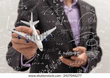 mathematicians concept. Handsome man thinking on blue background, graphic image idea, man mathematicians are calculating with technology smartphone in a financial company 