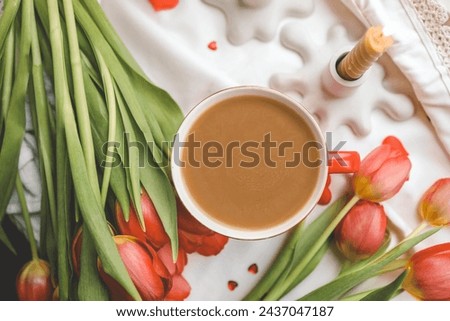 Cup of coffee, tulips and candles, spring atmosphere.
