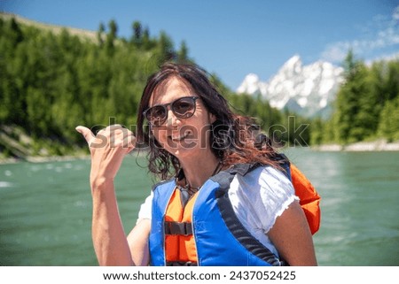 A beautiful woman on a boat excursion to Grand Teton National Park.