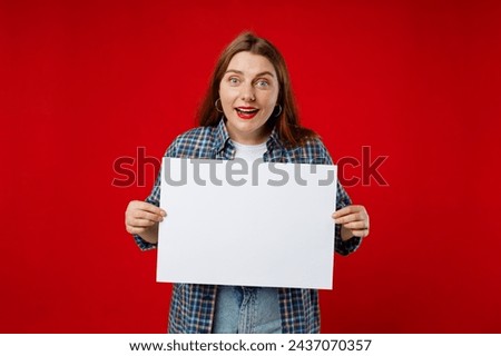 Beautiful 30s woman holding a blank advertisement banner isolated over red background. Young woman holding sign business board