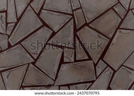 Close-up top view of various geometric shaped gray tiles on floor with red lines. Copy space for your text or decoration. Abstract surface background theme.	
