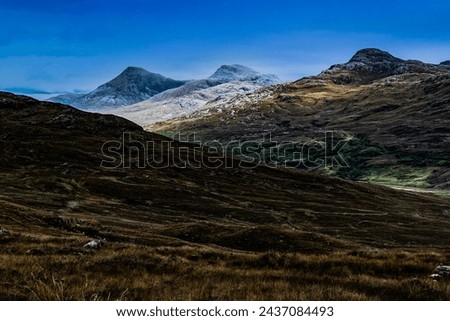 View across moorland to distant mountains Royalty-Free Stock Photo #2437084493
