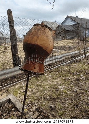 Clay jug on a pole in a courtyard in Ukraine. Clay jug on a pole in the courtyard of a village house.