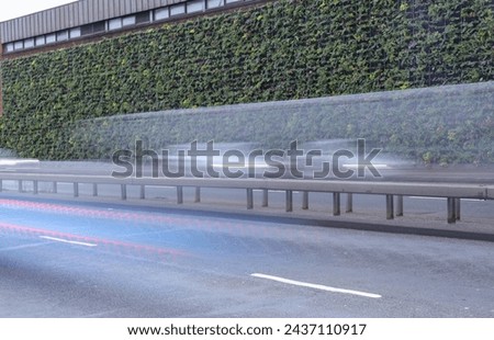 A green wall will be removing the air pollutants of the cars that speed in front of it.