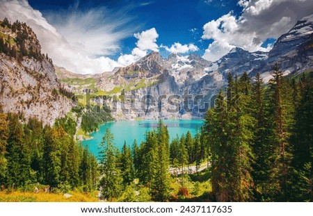 Perfect summer view of the lake Oeschinensee in sunny day. Location Swiss alps, Switzerland, Kandersteg district, Europe. Vibrant photo wallpaper. Image of exotic place. Discover the beauty of earth. Royalty-Free Stock Photo #2437117635