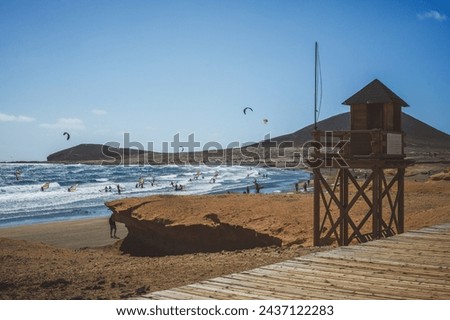El Medano, a beach and base for wind surfers on a sunny day. Tenerife, Spain. Royalty-Free Stock Photo #2437122283