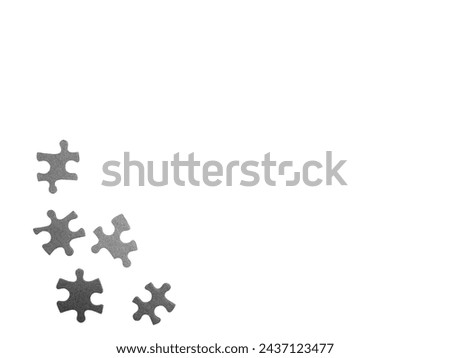 Frame formed of grey puzzle pieces with noise or grain. Photo of puzzle pieces isolated against white background. Business, logic, conceptual background