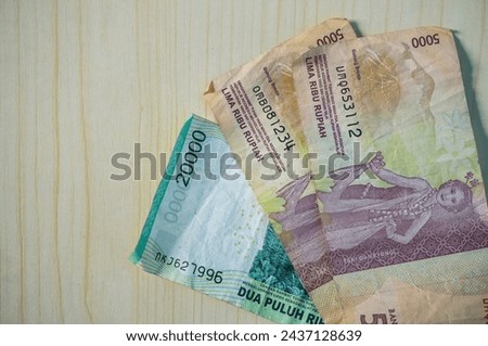 Rupiah banknote on wood background. Money photo concept.