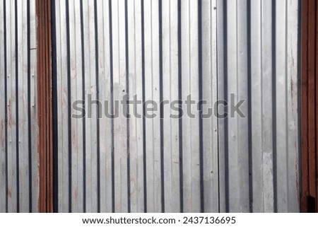 Steel wall. Garage for a car. Silver metal profile. Ribbed surface.