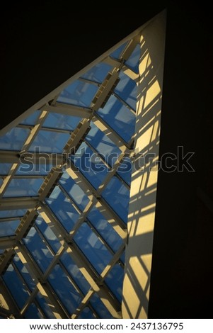 Glass roof. Interior of building. Light through roof. Large window opening.