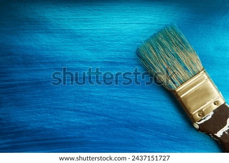 A brush on a blue nacreous color painted background. Abstract background. Royalty-Free Stock Photo #2437151727