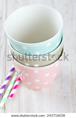 polka dot cups on wooden surface