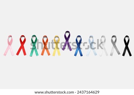 Different colorful ribbons on grey background. Cancer awareness concept