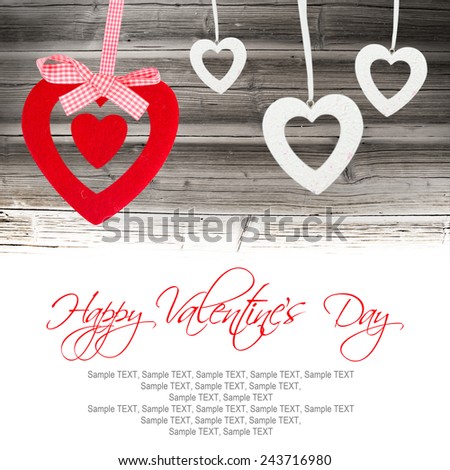 Hearts hanging on wooden background with white space
