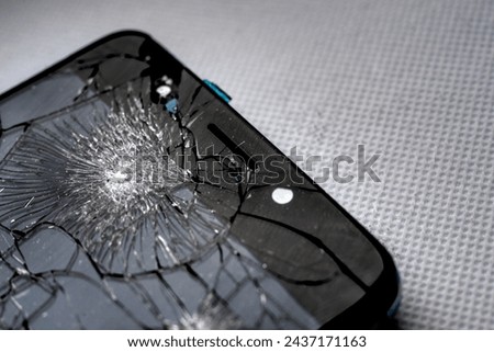 Fragment of smartphone with broken screen. Selective focus.
