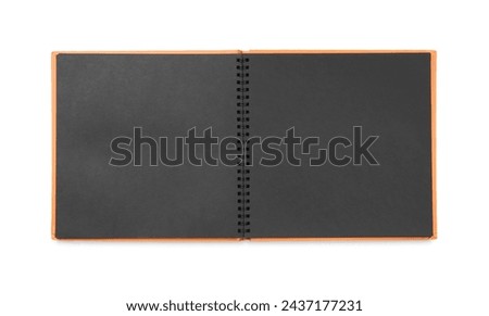 Open photo album with black pages isolated on white, top view. Space for text