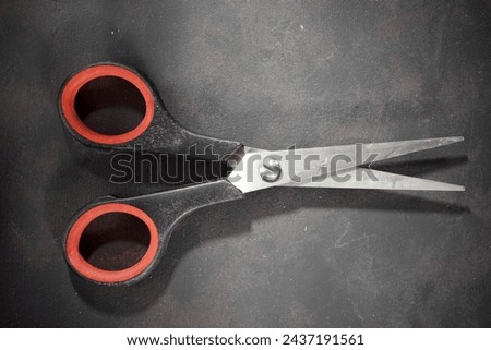 Close up of a disused metallic shears on a work bench. Royalty-Free Stock Photo #2437191561